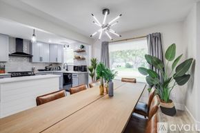 Desoto house for rent - A modern kitchen with a wooden table and chairs.
