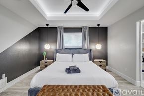 Desoto house for rent - A bedroom with a large bed and a ceiling fan.