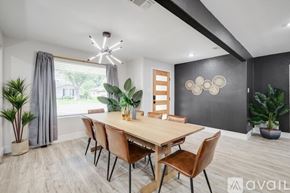 Desoto house for rent - A dining room with a wooden table and chairs.