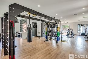 Lewisville apartment for rent - A gym with a variety of equipment including a punching bag and weight racks.