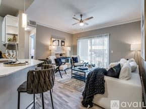 Lewisville apartment for rent - A living room with a white couch, a coffee table, and a ceiling fan.