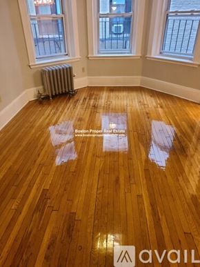 Boston apartment for rent - A room with wooden flooring and two windows.