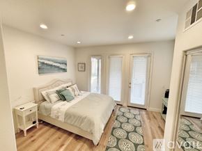 Huntington Beach townhouse for rent - A bedroom with a large bed and a painting on the wall.