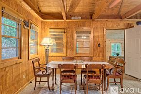 Rabun Gap house for rent - A wooden dining room with a table set for six.