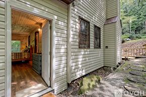 Rabun Gap house for rent - A house with a white exterior and a wooden porch.