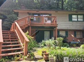 Clayton apartment for rent - A house with a deck and stairs leading to the front door.