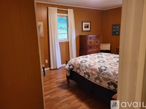 Clayton apartment for rent - A bedroom with a bed, dresser, and window.