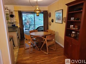 Clayton apartment for rent - A dining room with a wooden table and chairs.