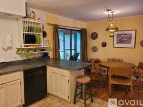 Clayton apartment for rent - A kitchen with a table and chairs in front of a window.