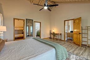 Clayton house for rent - A bedroom with a large bed and a ceiling fan.