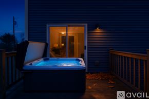 Bangor townhouse for rent - A house with a grey exterior and a wooden deck.
