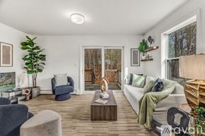 Bangor townhouse for rent - A living room with a kitchen area in the background.