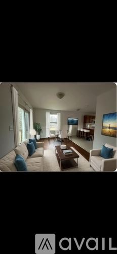Bangor townhouse for rent - A living room with a couch, a coffee table, and a television.