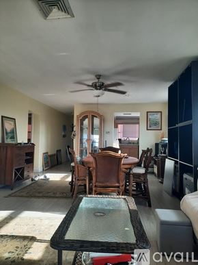 St. Pete Beach apartment for rent - A living room with a dining table and chairs.