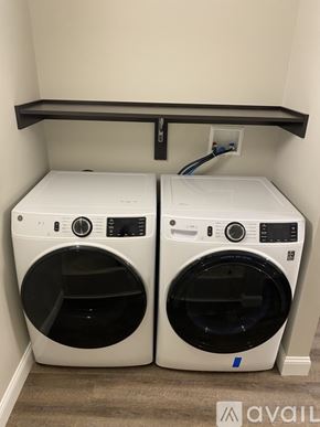 New Hartford apartment for rent - Two white front loading washing machines in a small laundry room.