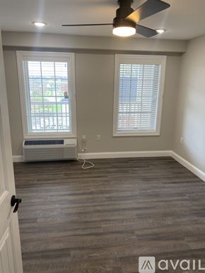 New Hartford apartment for rent - A room with a ceiling fan and a window with blinds.