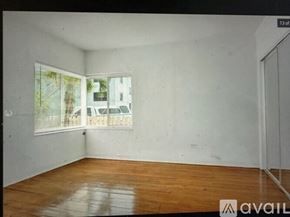 Miami Beach apartment for rent - Empty room with wooden floor and white walls.