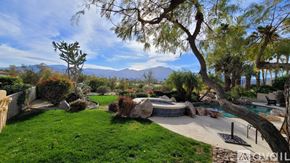 La Quinta house for rent - A backyard with a pool and a tree.