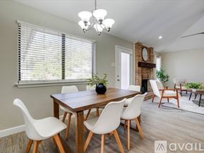 Lewisville house for rent - A dining room with a wooden table and white chairs.