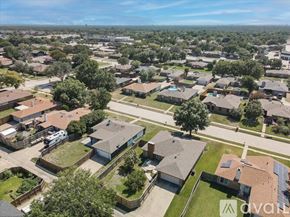 Lewisville house for rent - A bird's eye view of a residential neighborhood with houses and trees.