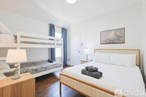 Corinth house for rent - A bedroom with a large bed and a bunk bed.