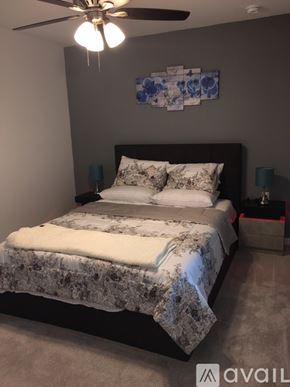 Ave Maria condo for rent - A bedroom with a large bed and a ceiling fan.