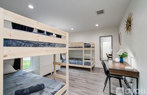 Friendswood house for rent - A bedroom with two bunk beds and a desk.