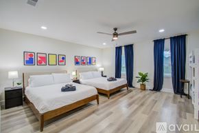 Friendswood house for rent - A bedroom with two beds and a ceiling fan.