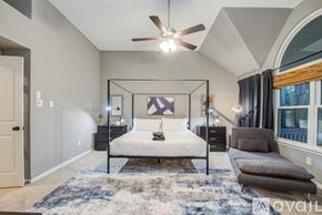 Spring house for rent - A bedroom with a four poster bed and a rug on the floor.