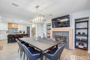 Spring house for rent - A modern dining room with a wooden table and chairs.
