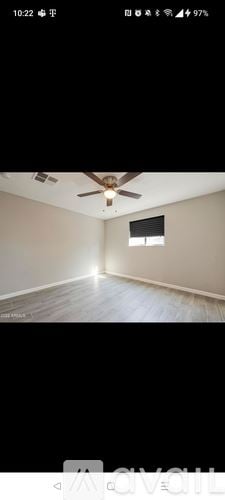 Surprise house for rent - A room with a ceiling fan and a window.