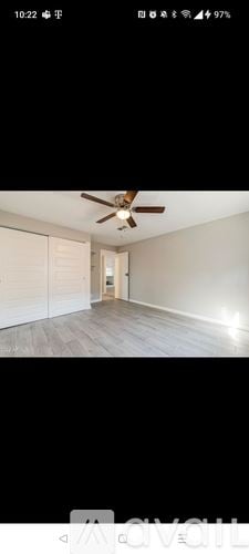 Surprise house for rent - A room with a ceiling fan and wooden flooring.