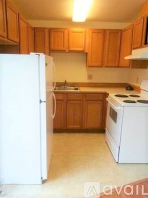 Lynnwood apartment for rent - A kitchen with white appliances and wooden cabinets.