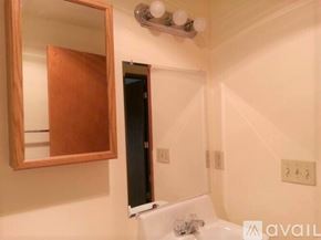 Lynnwood apartment for rent - A bathroom with a mirror, sink, and a door.