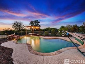Denton house for rent - A pool with a hot tub and a gazebo in the background.