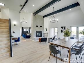 Denton house for rent - A modern dining room with a wooden table and chairs.