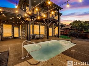 Lewisville house for rent - A pool in a backyard with lights strung above it.