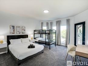Lewisville house for rent - A bedroom with a large bed and a bunk bed.