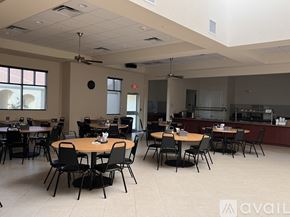 Tavares house for rent - A spacious room with tables and chairs is available for use.