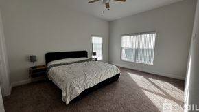 Tavares house for rent - A bedroom with a large bed and a ceiling fan.