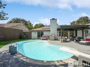 Plano house for rent - A backyard with a pool and a house.