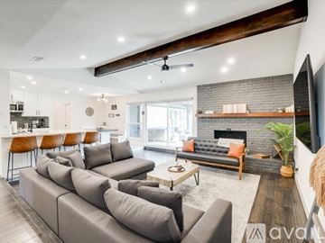 Plano house for rent - A modern living room with a grey sofa set and a fireplace.