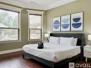 Kennedale house for rent - A bedroom with a large bed and a pair of headphones on the bed.
