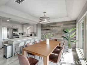 Rockwall house for rent - A modern kitchen with a wooden dining table and chairs.