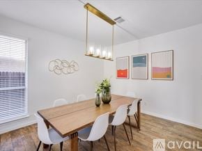 Haltom City house for rent - A dining room with a wooden table and white chairs.
