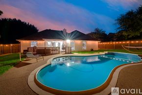 North Richland Hills house for rent - A house with a pool in the backyard at night.