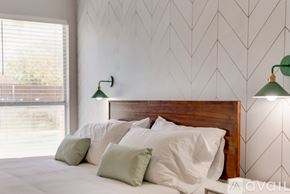 North Richland Hills house for rent - A bedroom with a large bed and two green lampshades.