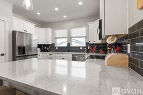 Lehi apartment for rent - A modern kitchen with a marble countertop and stainless steel appliances.
