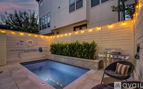 Houston house for rent - A backyard with a pool and a hot tub.