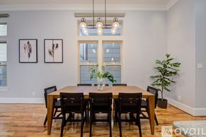 Houston house for rent - A dining room with a wooden table and chairs.
